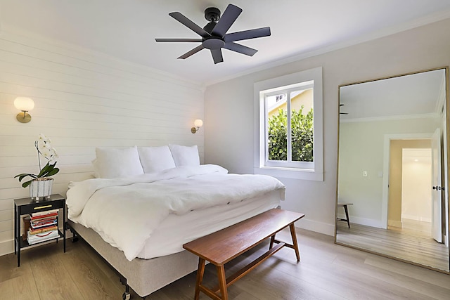 1630 N Ocean Breeze, Lake Worth Beach, FL 33460 - bedroom with crown molding, light wood-style floors, ceiling fan, and wooden walls