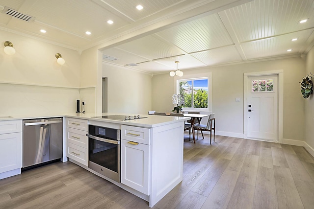1630 N Ocean Breeze, Lake Worth Beach, FL 33460 - kitchen featuring appliances with stainless steel finishes, a peninsula, light wood finished floors, white cabinetry, and ornamental molding