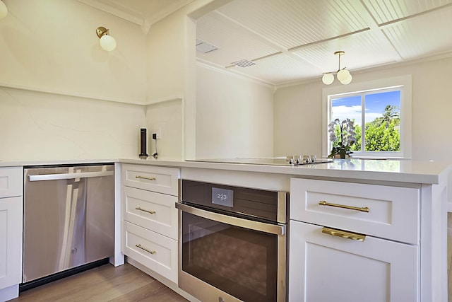 1630 N Ocean Breeze, Lake Worth Beach, FL 33460 - kitchen with dishwasher, crown molding, light countertops, light wood-style floors, and white cabinets