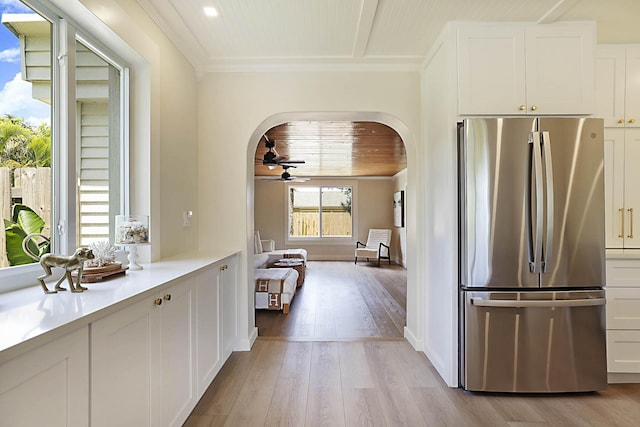 1630 N Ocean Breeze, Lake Worth Beach, FL 33460 - kitchen featuring freestanding refrigerator, arched walkways, a ceiling fan, white cabinetry, and light countertops