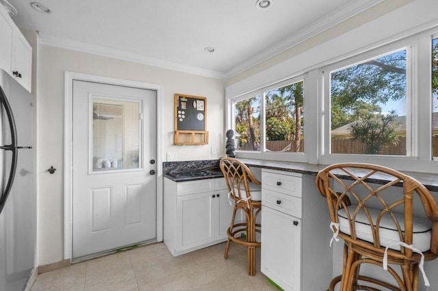 1630 N Ocean Breeze, Lake Worth Beach, FL 33460 - home office with ornamental molding, light tile patterned floors, and recessed lighting