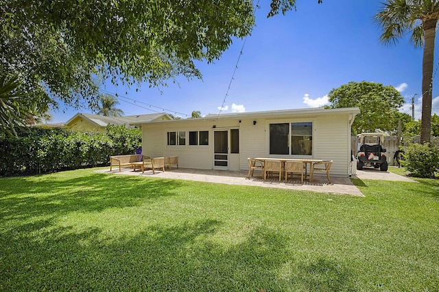 1630 N Ocean Breeze, Lake Worth Beach, FL 33460 - rear view of house featuring a patio area, a yard, and an outdoor living space