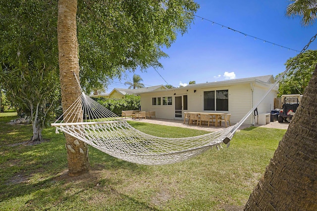 1630 N Ocean Breeze, Lake Worth Beach, FL 33460 - back of property featuring a patio and a yard