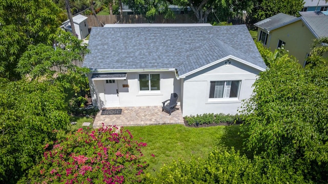 1630 N Ocean Breeze, Lake Worth Beach, FL 33460 - rear view of house with a shingled roof and stucco siding