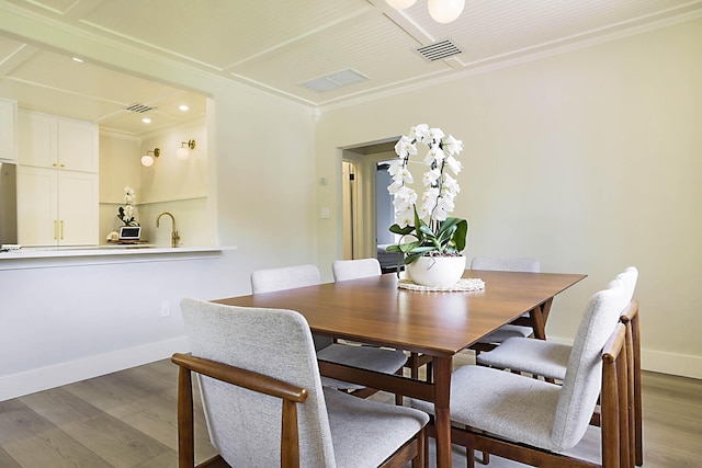 1630 N Ocean Breeze, Lake Worth Beach, FL 33460 - dining space with wood finished floors, crown molding, and recessed lighting