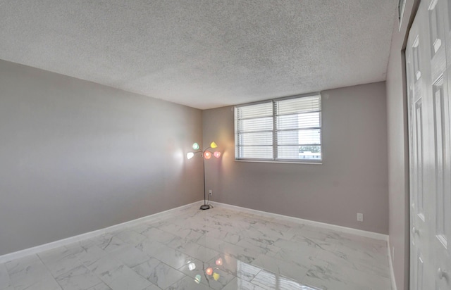 5500 NW 2nd Ave Three, Unit Three, Boca Raton, FL 33487 - unfurnished room with marble finish flooring, baseboards, and a textured ceiling
