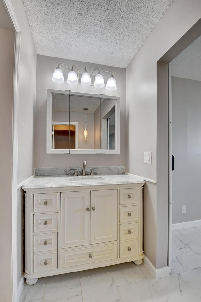5500 NW 2nd Ave Three, Unit Three, Boca Raton, FL 33487 - bathroom with marble look tile flooring, baseboards, vanity, and a textured ceiling