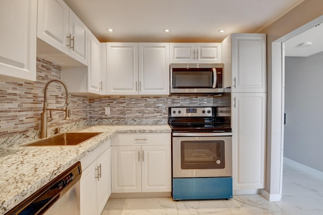 5500 NW 2nd Ave Three, Unit Three, Boca Raton, FL 33487 - kitchen featuring stainless steel appliances, a sink, light marble finish flooring, white cabinetry, and recessed lighting