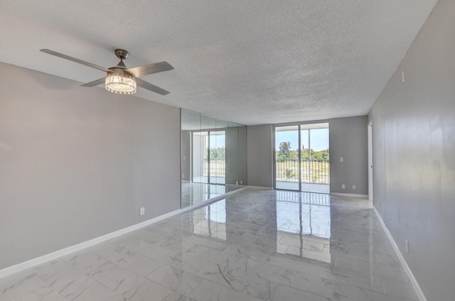 5500 NW 2nd Ave Three, Unit Three, Boca Raton, FL 33487 - spare room featuring baseboards, a textured ceiling, marble finish flooring, and a ceiling fan