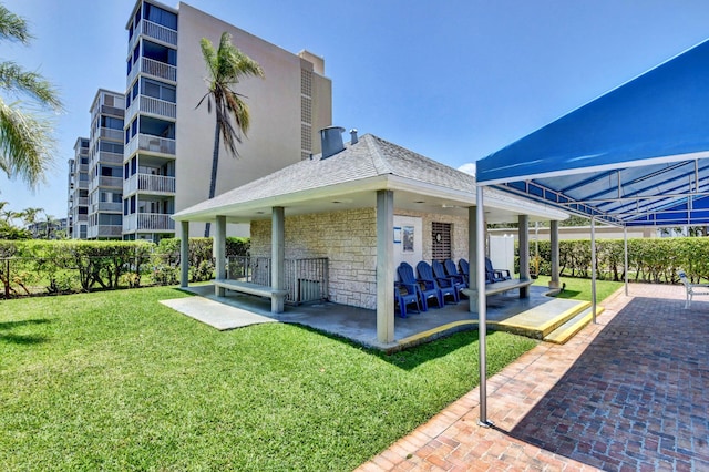 5500 NW 2nd Ave Three, Unit Three, Boca Raton, FL 33487 - back of house featuring stone siding and a yard