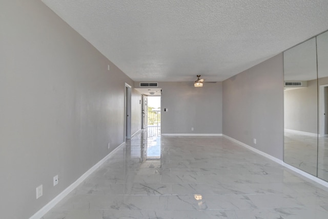 5500 NW 2nd Ave Three, Unit Three, Boca Raton, FL 33487 - spare room featuring a ceiling fan, a textured ceiling, baseboards, and light marble finish flooring