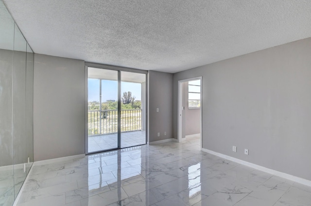 5500 NW 2nd Ave Three, Unit Three, Boca Raton, FL 33487 - unfurnished room with baseboards, light marble finish floors, and a textured ceiling