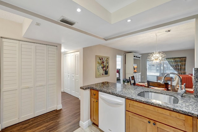 2901 NW 46th Ave Unit 101, Lauderdale Lakes, FL 33313 - kitchen with white dishwasher, dark stone counters, light wood finished floors, a chandelier, and hanging light fixtures