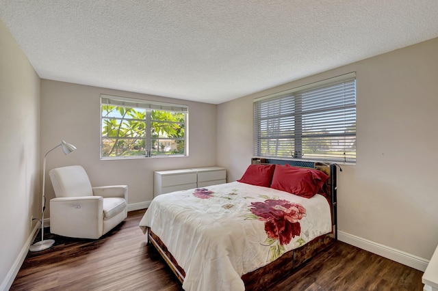 2901 NW 46th Ave Unit 101, Lauderdale Lakes, FL 33313 - bedroom featuring multiple windows, wood finished floors, and a textured ceiling