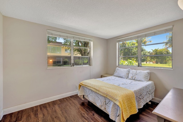 2901 NW 46th Ave Unit 101, Lauderdale Lakes, FL 33313 - bedroom featuring multiple windows, wood finished floors, and a textured ceiling