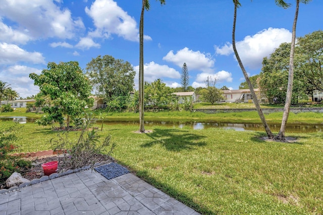 2901 NW 46th Ave Unit 101, Lauderdale Lakes, FL 33313 - view of grassy yard with a water view and a patio area