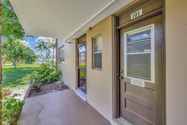 2901 NW 46th Ave Unit 101, Lauderdale Lakes, FL 33313 - doorway to property featuring stucco siding