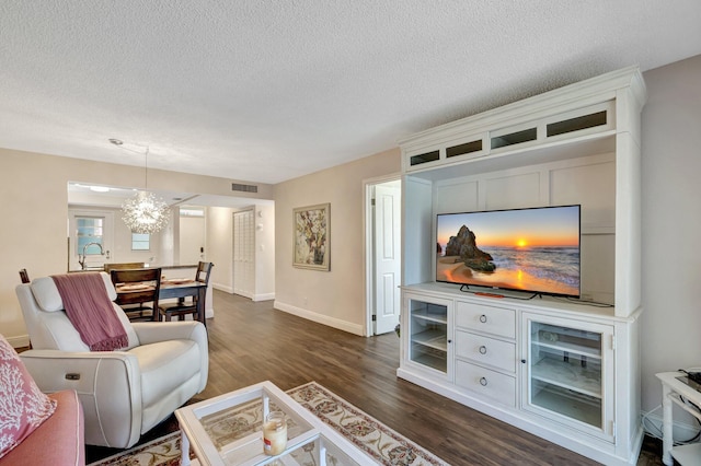 2901 NW 46th Ave Unit 101, Lauderdale Lakes, FL 33313 - living room featuring a textured ceiling, dark wood-type flooring, and a chandelier