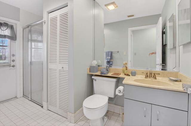 9645 Carousel Cir N, Boca Raton, FL 33434 - full bath featuring a closet, toilet, vanity, a stall shower, and tile patterned floors