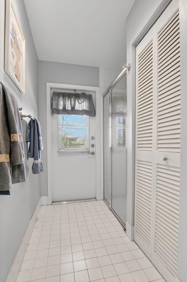 9645 Carousel Cir N, Boca Raton, FL 33434 - bathroom with a shower stall, a closet, and tile patterned floors