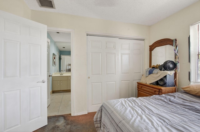 9645 Carousel Cir N, Boca Raton, FL 33434 - tiled bedroom featuring a closet, carpet floors, a textured ceiling, and a sink