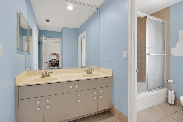 9645 Carousel Cir N, Boca Raton, FL 33434 - full bathroom with double vanity, tile patterned floors, shower / bath combination with glass door, and baseboards