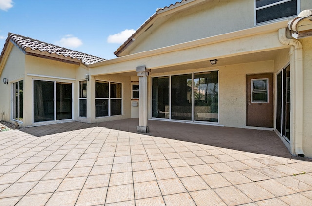 9645 Carousel Cir N, Boca Raton, FL 33434 - rear view of property with a patio area, stucco siding, and a tile roof