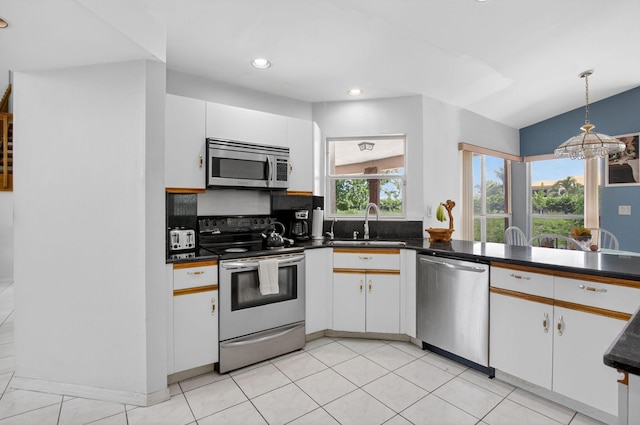 9645 Carousel Cir N, Boca Raton, FL 33434 - kitchen featuring appliances with stainless steel finishes, a sink, dark countertops, hanging light fixtures, and recessed lighting