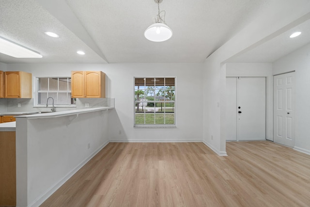 17832 43rd Rd N, Loxahatchee, FL 33470 - kitchen featuring light countertops, light wood finished floors, recessed lighting, decorative light fixtures, and baseboards