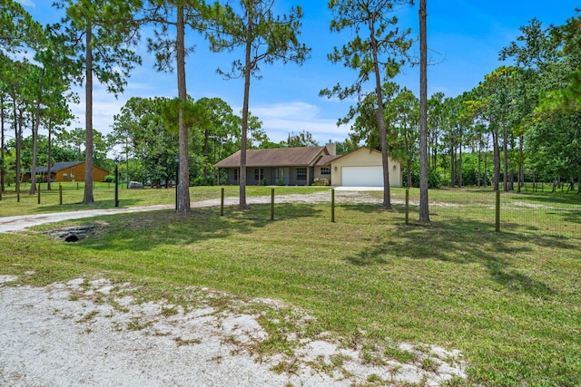 17832 43rd Rd N, Loxahatchee, FL 33470 - view of front facade featuring a front yard, a chimney, and driveway
