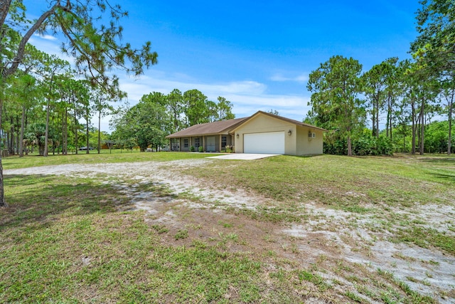 17832 43rd Rd N, Loxahatchee, FL 33470 - view of green lawn with an attached garage and driveway