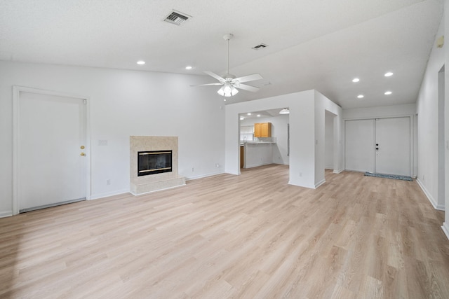 17832 43rd Rd N, Loxahatchee, FL 33470 - unfurnished living room with baseboards, recessed lighting, light wood-style flooring, ceiling fan, and a high end fireplace