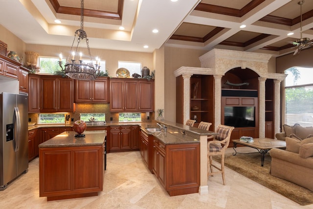 123 Grand Palm Way, Palm Beach Gardens, FL 33418 - kitchen with stainless steel refrigerator with ice dispenser, open floor plan, ornate columns, crown molding, and a peninsula