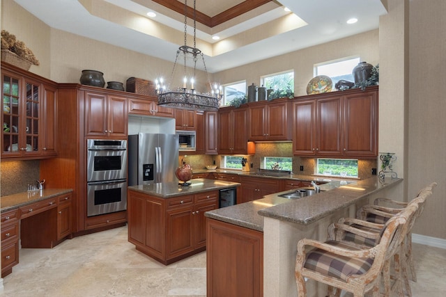 123 Grand Palm Way, Palm Beach Gardens, FL 33418 - kitchen with stainless steel appliances, a towering ceiling, backsplash, glass insert cabinets, and pendant lighting