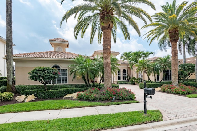 123 Grand Palm Way, Palm Beach Gardens, FL 33418 - mediterranean / spanish house with stucco siding, curved driveway, and a tile roof