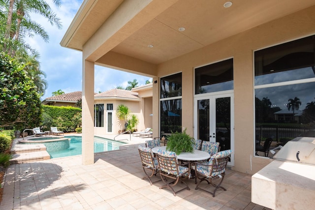 123 Grand Palm Way, Palm Beach Gardens, FL 33418 - view of patio / terrace with an in-ground hot tub, an outdoor pool, and french doors