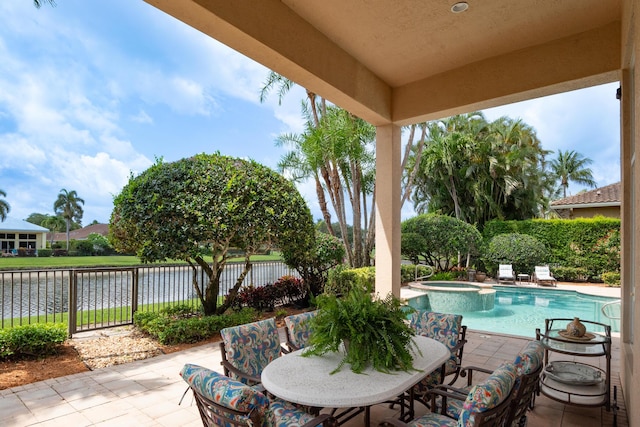 123 Grand Palm Way, Palm Beach Gardens, FL 33418 - view of patio / terrace featuring a water view, a pool with connected hot tub, and outdoor dining space
