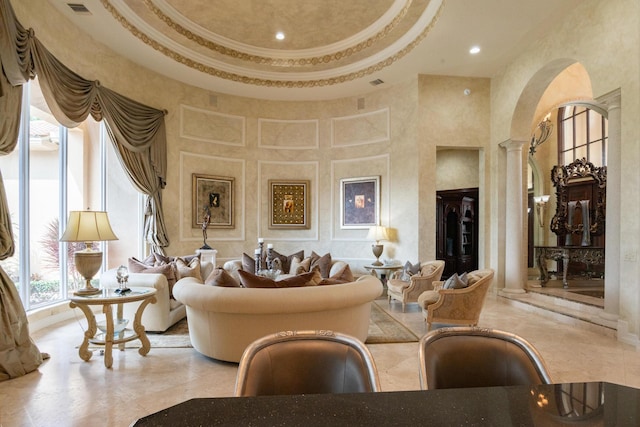 123 Grand Palm Way, Palm Beach Gardens, FL 33418 - living area with ornate columns, a towering ceiling, a raised ceiling, and recessed lighting