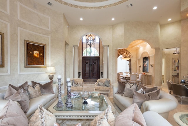 123 Grand Palm Way, Palm Beach Gardens, FL 33418 - living room featuring arched walkways, ornate columns, recessed lighting, a high ceiling, and a chandelier