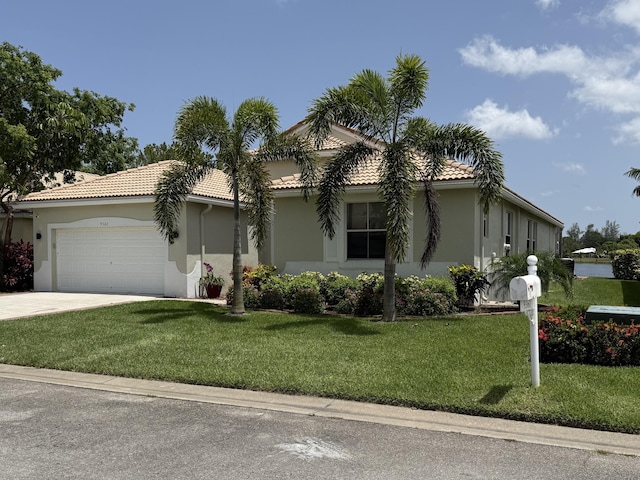 9360 Cove Point Cir, Boynton Beach, FL 33472 - view of front of house featuring an attached garage, a tile roof, concrete driveway, a front lawn, and stucco siding