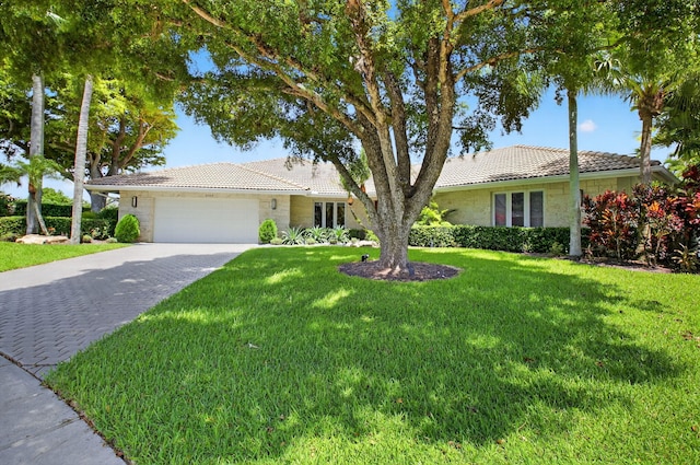 3765 Canterbury Ct, Boca Raton, FL 33434 - ranch-style home with a tile roof, a garage, decorative driveway, a front lawn, and stone siding