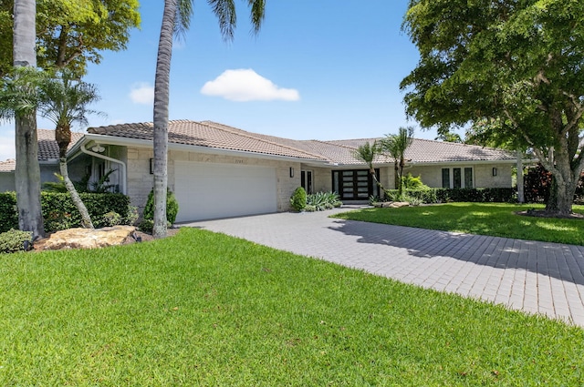 3765 Canterbury Ct, Boca Raton, FL 33434 - ranch-style home with a tile roof, an attached garage, a front lawn, driveway, and french doors