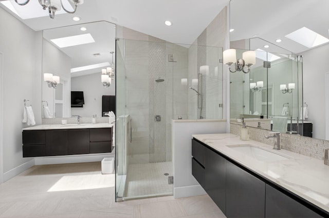 3765 Canterbury Ct, Boca Raton, FL 33434 - full bath with a skylight, a chandelier, a shower stall, two vanities, and vaulted ceiling