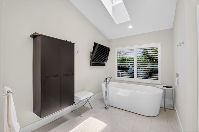 3765 Canterbury Ct, Boca Raton, FL 33434 - bathroom featuring a skylight, a freestanding bath, vaulted ceiling, and recessed lighting