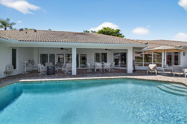 3765 Canterbury Ct, Boca Raton, FL 33434 - back of property featuring ceiling fan, outdoor dining space, an outdoor pool, and stucco siding