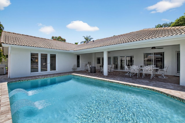 3765 Canterbury Ct, Boca Raton, FL 33434 - back of house with a ceiling fan, a tile roof, an outdoor pool, stucco siding, and outdoor dining space