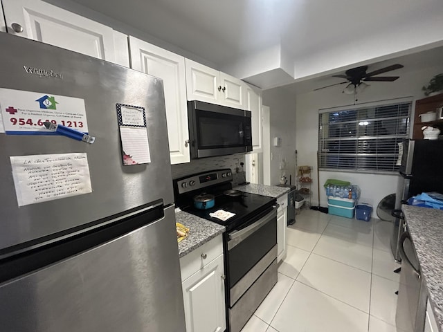 3099 NW 48th Ave Unit 163, Lauderdale Lakes, FL 33313 - kitchen with stainless steel appliances, light tile patterned floors, white cabinets, ceiling fan, and light stone counters