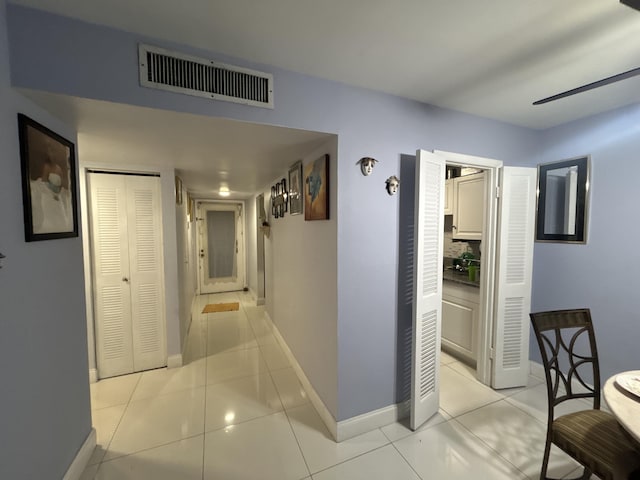 3099 NW 48th Ave Unit 163, Lauderdale Lakes, FL 33313 - hallway with baseboards and light tile patterned floors