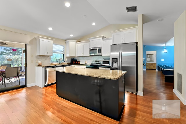 2850 NW 15th St, Delray Beach, FL 33445 - kitchen featuring appliances with stainless steel finishes, light wood-style floors, a kitchen island, white cabinets, and a sink