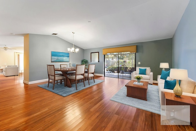2850 NW 15th St, Delray Beach, FL 33445 - dining area featuring vaulted ceiling, wood finished floors, a chandelier, and baseboards
